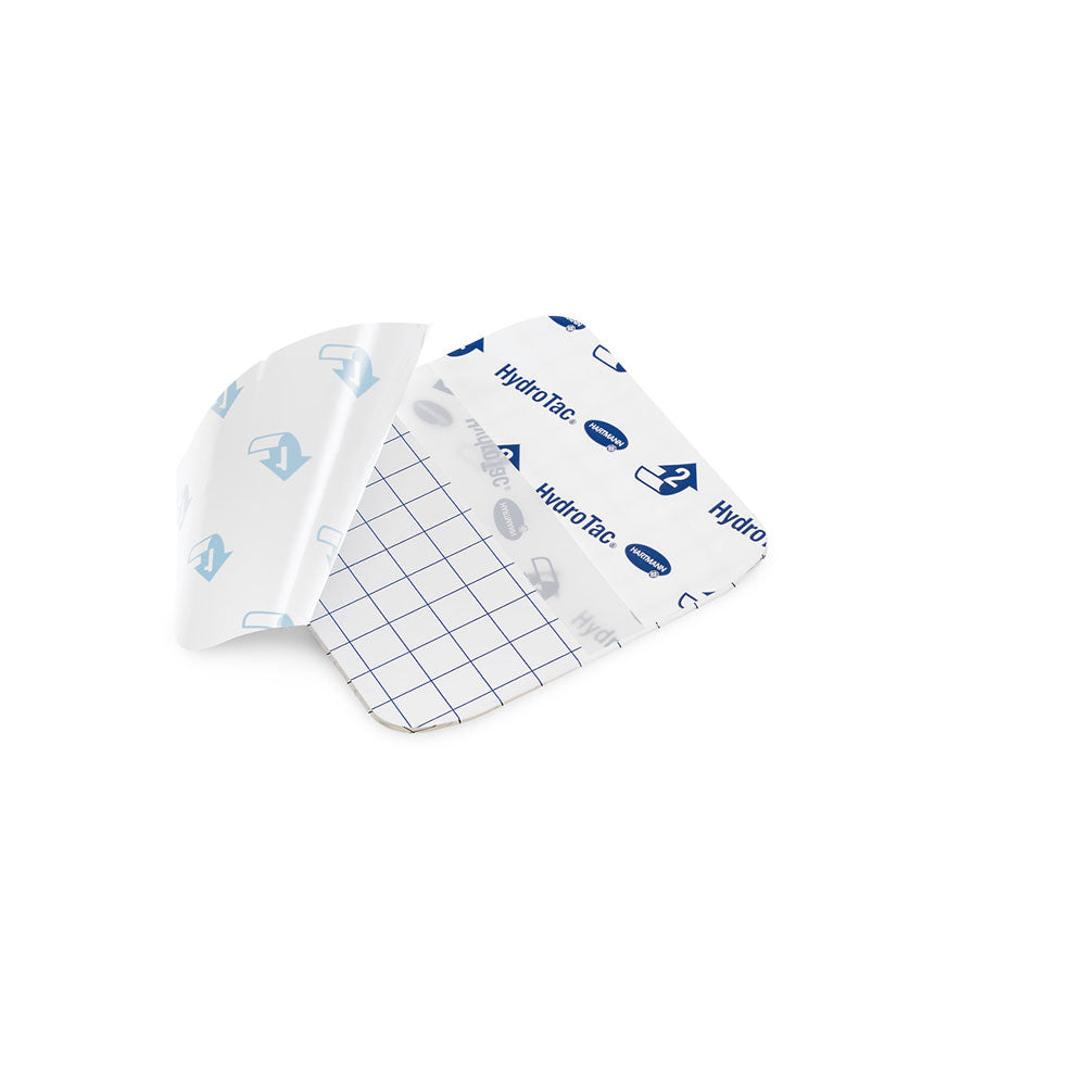 Hydrogelverband HydroTac transparent, gefaltetes Stück mit Aufdruck und blauem Raster