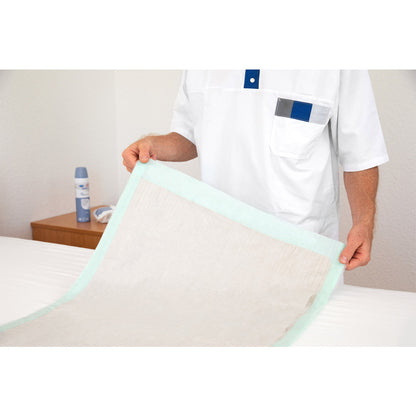 Inkontinenzunterlage Hartmann MoliCare® Bed Mat Eco auf dem Bett, hellbeige mit türkisfarbenem Rand