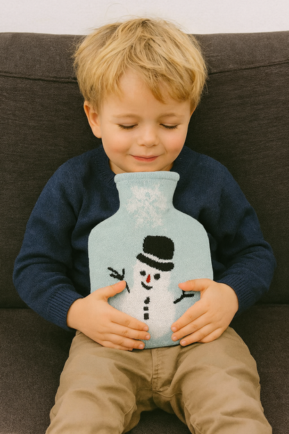 Wärmflasche mit Schneemann-Strickbezug, hellblau; Kind sitzt und hält sie